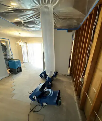 Plastic containment and ducted drying set up in a wet room with flood-cut walls