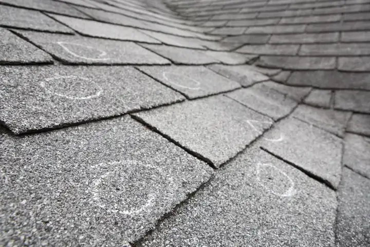 Chalk circles marking hail strikes on roof shingles after a Denton County storm